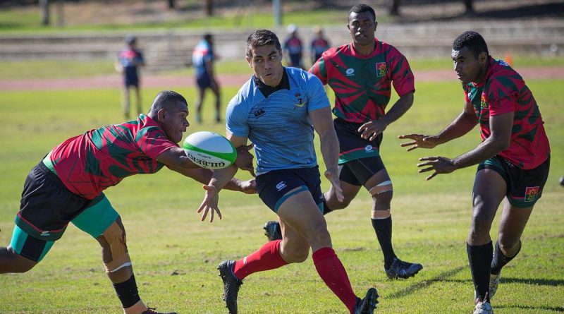 A player from the Republic of Fiji Military Forces team, left, attempts to intercept Craftsman Shaun Coel during the Malo-Bula Cup at Gallipoli Barracks. Story by Captain Jesse Robilliard. Photo by Private Hamid Farahani.