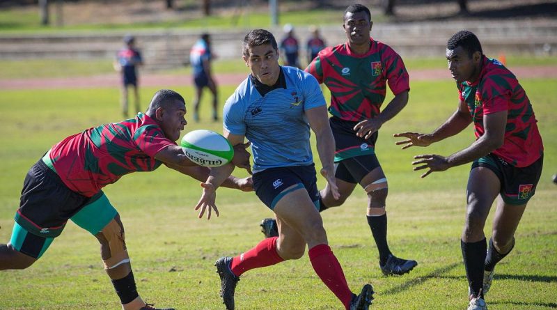 A player from the Republic of Fiji Military Forces team, left, attempts to intercept Craftsman Shaun Coel during the Malo-Bula Cup at Gallipoli Barracks. Story by Captain Jesse Robilliard. Photo by Private Hamid Farahani.