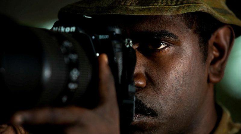 Private Daniel Charlie takes a photo of a watercraft approaching Boigu Island. Story and photo by Sergeant Sebastian Beurich.