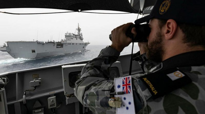 Midshipman Thomas Armstrong checks HMAS Parramatta's distance from Japan Maritime Self-Defense Force vessel JS Ise with laser range-finding binoculars during Exercise ARC21. Story and photo by Leading Seaman Jarrod Mulvihill.