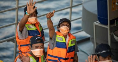 Rescued Indonesian fishermen wave goodbye to the crew of HMAS Anzac from the Indonesian Navy patrol vessel KRI Escolar following their return to Bali. Story by Lieutenant Geoff Long. Photo by Leading Seaman Thomas Sawtell.