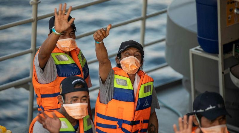 Rescued Indonesian fishermen wave goodbye to the crew of HMAS Anzac from the Indonesian Navy patrol vessel KRI Escolar following their return to Bali. Story by Lieutenant Geoff Long. Photo by Leading Seaman Thomas Sawtell.