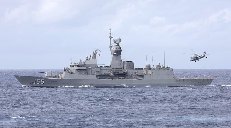 HMAS Ballarat and her embarked MH-60R helicopter on the ship's south-east Asian deployment, May 2021. Photo by Leading Seaman Jarrod Mulvihill.