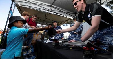 Leading Aircraftman Nathan Thompson of the Air Force Drone Racing Team gives Hawkesbury Show visitor Pranav a closer look at a racing drone. Story by Eamon Hamilton. Photo by Corporal David Said.