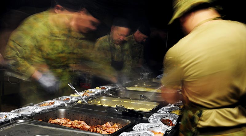 Australian Army chefs and stewards prepare 'hot-box' meals in a field kitchen at Shoalwater Bay, Queensland, during Exercise Talisman Saber 2013. Photo by Corporal Jake Sims.