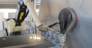 The robotic arm of the Semi-automated Explosive Ordnance Inerting Capability and the filtered catch-buckets that collect the extracted material.