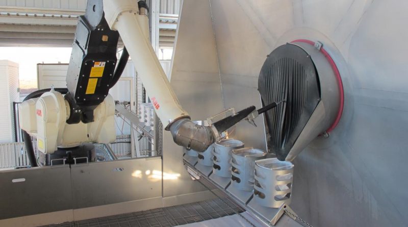 The robotic arm of the Semi-automated Explosive Ordnance Inerting Capability and the filtered catch-buckets that collect the extracted material.