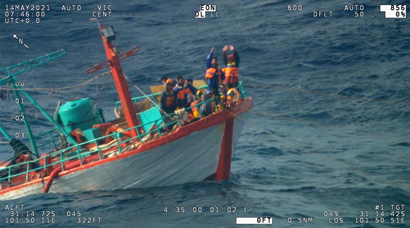 Indonesian fishermen wave to a RAAF P8-A Poseidon from their sinking fishing trawler 670 nautical miles off Perth, WA.