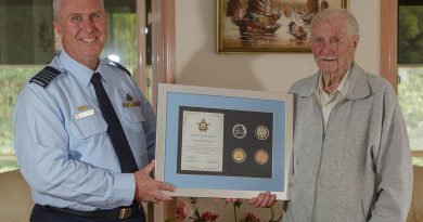 Senior Australian Defence Force Officer for RAAF Base Williamtown Group Captain Anthony Stainton presents George Lincoln an Air Force centenary memento. Story by Wing Commander Sue Yates. Photo by Sergeant David Gibbs.