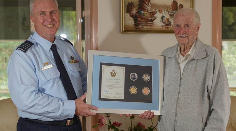 Senior Australian Defence Force Officer for RAAF Base Williamtown Group Captain Anthony Stainton presents George Lincoln an Air Force centenary memento. Story by Wing Commander Sue Yates. Photo by Sergeant David Gibbs.