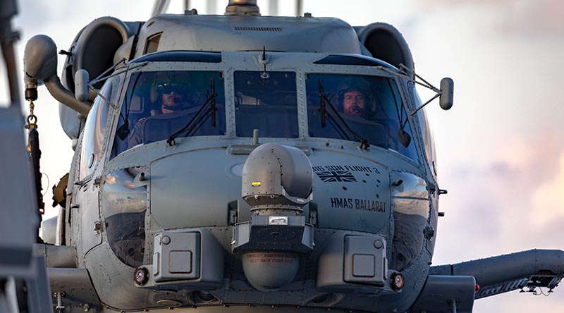 Royal Australian Navy pilots Lieutenant Benjamin Flood and Lieutenant Commander Matthew Schroder at the controls of an 816SQN MH-60R helicopter on HMAS Ballarat. Photo by Leading Seaman Shane Cameron.