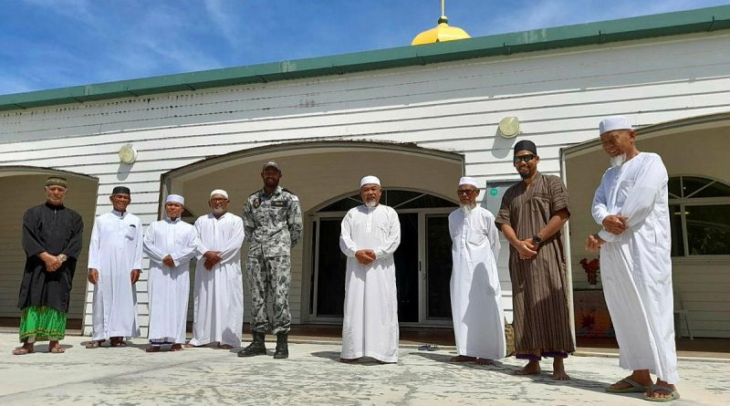 Able Seaman Ebrahim Dollie with members of the Cocos Keeling Islands mosque. Story by Lieutenant Gordon Carr-Gregg. Photo by Lance Corporal Casey Flanagan.