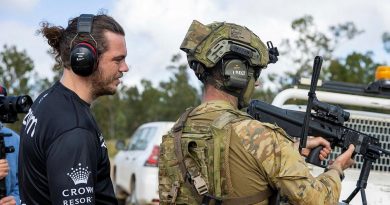 Captain Declan James explains the workings of an EF88 Austeyr Rifle to former South Sydney Rabbitoh player Ethan Lowe during his visit to Shoalwater Bay Training Area, Queensland. Story by Captain Jesse Robilliard. Photo by Corporal Nicole Dorrett.