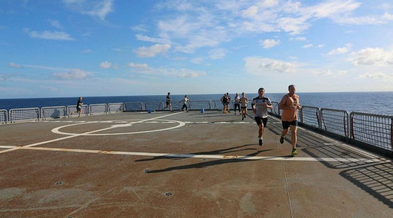 Participants in the HMAS Sirius parkrun event run laps on the ship's flight deck. Story by Lieutenant Geoff Long. Photo by Lieutenant Sarah Lucinsky.