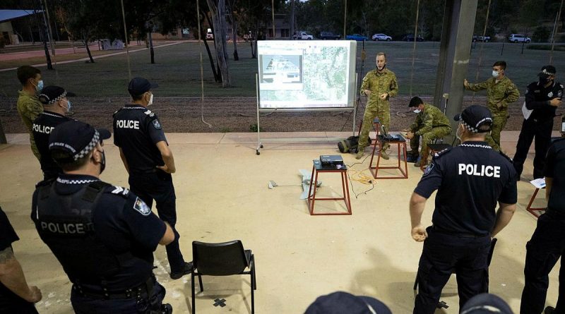 Corporal Ryan Waterham, from the 3rd Battalion, Royal Australian Regiment, demonstrates the unit's unmanned aerial system to Queensland Police officers at Lavarack Barracks. Story by Captain Lily Charles. Photo by Corporal Brandon Grey.