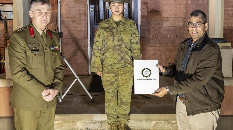 Reservist Private Izzy Kim, centre, with her civilian employer, manager Digital Analytics and Business Enablement at HCF Australia Hari Somayajula receiving a certificate of appreciation from Brigadier Mick Garraway. Story by Alex DeValentin. Photo by Corporal Dan Pinhorn.