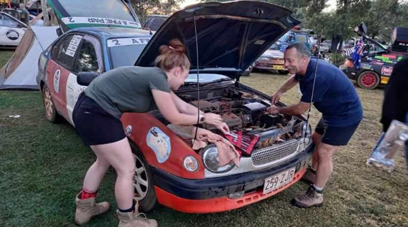 Major Lee Sankey and his daughter, Lydia, make some quick repairs to their vehicle during some down time in the Shitbox Rally.