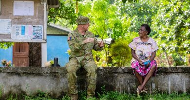 Captain Tim McPhee discusses the Vanuatu Government National Emergency Radio Network with Kerembei local Anika Bani during instillation. Photo by Corporal Olivia Cameron.