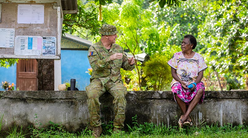 Captain Tim McPhee discusses the Vanuatu Government National Emergency Radio Network with Kerembei local Anika Bani during instillation. Photo by Corporal Olivia Cameron.