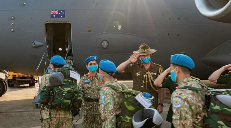 Australian Defence Attache to Vietnam Colonel Paul Foura and senior Vietnamese officers farewell Vietnamese Level Two Field Hospital personnel as they board an Air Force C-17A Globemaster III in Ho Chi Minh City. Photo by Cần Thơ Kỷ Yếu