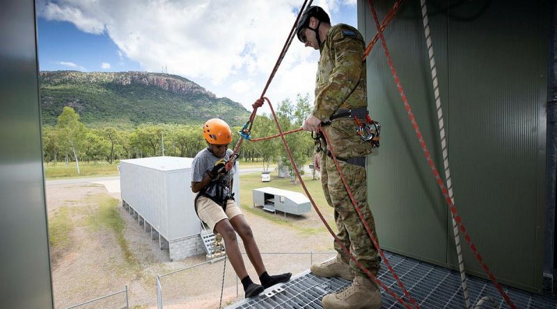 Lance Corporal Jordan Blake assists a participant of the Townsville Fire Youth Engagement Program during resilience activities at Lavarack Barracks. Story by Captain Diana Jennings. Photo by Corporal Brandon Grey.
