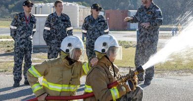 Senator for Victoria, Senator Raff Ciccone, Member for Ryan, Julian Simmonds and Senator for NSW Senator Hollie Hughes listening to Senior Instructor Chief Petty Officer Bryce Jackson explain fire hose techniques. Photo by Petty Officer Yuri Ramsey.