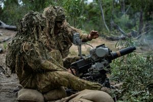 CAPTION: Soldiers from the 6th Battalion, Royal Australian Regiment fire an Automatic Grenade Launcher during a live-fire defence serial held for Exercise Diamond Walk at Shoalwater Bay, Queensland. Photo by Private Jacob Hilton.