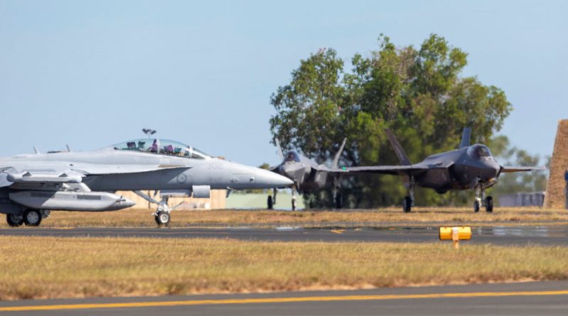 An Air Force EA-18G Growler, aircraft taxis past two F-35A Lightning II aircraft on its way to the runway, during exercise Arnhem Thunder held at RAAF Base Darwin, Northern Territory. Photo by Leading Aircraftman Stewart Gould.