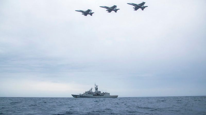 Three United States Navy EA-18G Growlers from VAQ-132 Squadron in formation over HMAS Ballarat in a Cooperative Activity during the ship's Regional Presence Deployment. Story by Lieutenant Gary McHugh. Photo by Leading Seaman Ernesto Sanchez.