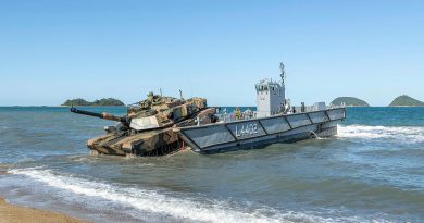 An Australian Army M1A1 Abrams Tank is loaded onto a Royal Australian Navy light landing craft, during Exercise Sea Explorer, Cowley Beach, Queensland. Story by Photo by Leading Aircraftwoman Jacqueline Forrester.