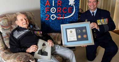 Senior ADF Officer RAAF Base Amberley Group Captain Iain Carty presents Air Force veteran Bill Heatherill with an Air Force 2021 commemorative memento in celebration of his 100th birthday. Story by Evita Ryan. Photo by Corporal Jesse Kane.