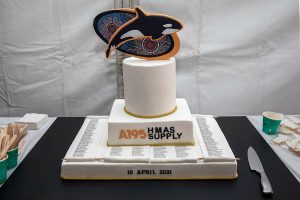 HMAS Supply's commissioning cake with killer whale and indigenous art background at Fleet Base East in Sydney, New South Wales. Photo by Petty Officer Justin Brown.