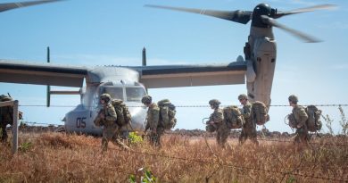 Australian Army soldiers carry their gear off a landing zone during Exercise Crocodile Response at Point Fawcett, Northern Territory. Story byLieutenant Gordon Carr-Gregg.