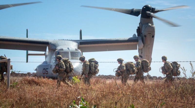 Australian Army soldiers carry their gear off a landing zone during Exercise Crocodile Response at Point Fawcett, Northern Territory. Story byLieutenant Gordon Carr-Gregg.