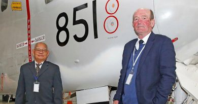 Skipper of refugee boat Nghia Hung, Tam Van Nguyen, with Royal Australian Navy Reserve Captain Chris Frost in front of Grumman Tracker 851 at the HARS Aviation Museum, Albion Park, NSW. Story and photo by Sergeant Dave Morley.