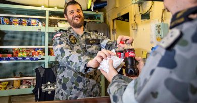 HMAS Ballarat's Assistant Canteen Manager Leading Seaman Timothy Boyd serves Able Seaman Daniel Johnson during deployment. Story by Lieutenant Geoff Long. Photo by Leading Seaman Ernesto Sanchez.