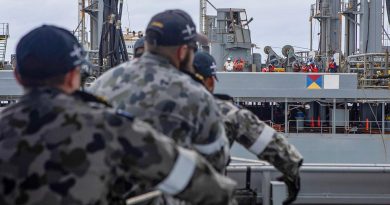 HMAS Ballarat's Ship's Company heave in a messenger line during a replenishment at sea with USNS Big Horn. Story by Lieutenant Gary McHugh. Photo by Leading Seaman Ernesto Sanchez.