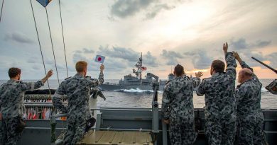 HMAS Ballarat's ship's company wave farewell as Japan Maritime Self-Defense Force Ship Murasame passes by after completing training together. Story by Lieutenant Gary McHugh. Photo by Leading Seaman Ernesto Sanchez.