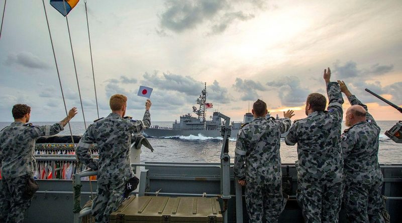 HMAS Ballarat's ship's company wave farewell as Japan Maritime Self-Defense Force Ship Murasame passes by after completing training together. Story by Lieutenant Gary McHugh. Photo by Leading Seaman Ernesto Sanchez.