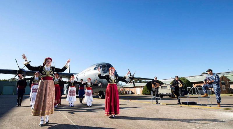 Dancers from the Cretan Association of Sydney perform in front of a C-130J Hercules as No. 37 Squadron avionics technician Leading Aircraftman Yianni Skoulakis, right, plays the laouto at RAAF Base Richmond. Story by Eamon Hamilton. Photo by Corporal David Said.