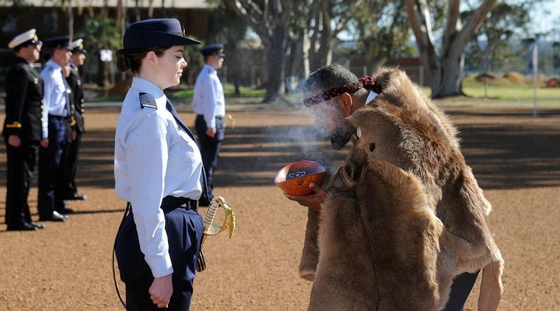 Pilot Officer Christina Way participates in a traditional smoking ceremony conducted by Whadjuk Elder Barry Winmar during the No. 261 Advanced Pilot Course Graduation at RAAF Base Pearce, WA. Story by Flight Lieutenant Julia Ravell. Photo by Chris Kershaw.