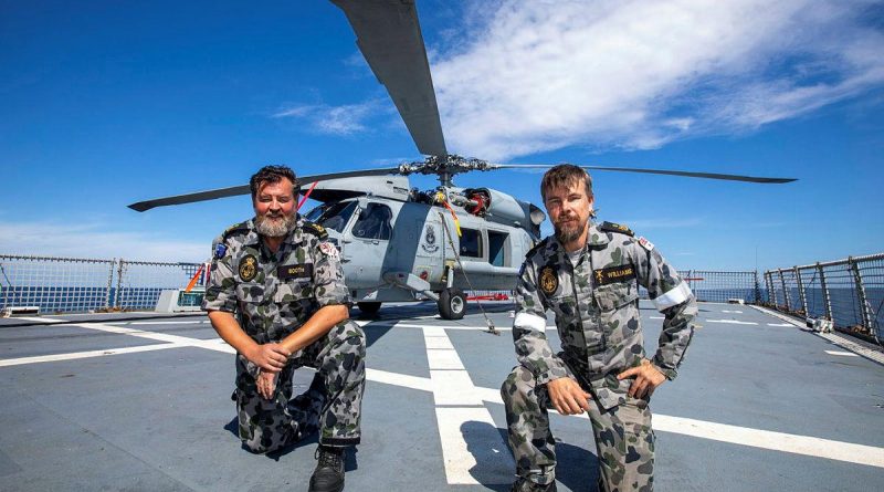 Petty Officers Andrew Booth, left, and Patrick Williams, from 816 Squadron's Flight 3 crew, with HMAS Ballarat's embarked MH-60R. Story by Lieutenant Gary McHugh. Photo by Leading Seaman Ernesto Sanchez.