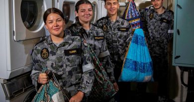 Able Seamen Cerys Zurek and Abbi Greenaway, Seaman Tiago Torres and Able Seaman Richard New display their personalised dhoby bags in the laundry of HMAS Ballarat. Story by Lieutenant Gary McHugh. Photo by Leading Seaman Ernesto Sanchez.