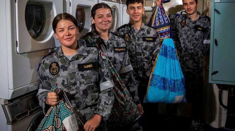 Able Seamen Cerys Zurek and Abbi Greenaway, Seaman Tiago Torres and Able Seaman Richard New display their personalised dhoby bags in the laundry of HMAS Ballarat. Story by Lieutenant Gary McHugh. Photo by Leading Seaman Ernesto Sanchez.