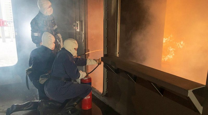 Participants in the Defence Work Experience Program are instructed how to use fire extinguishers in the School of Ship Safety and Survivability fire simulator during a visit to HMAS Cerberus. Story by Alex DeValentin. Photo by Leading Seaman James McDougall.