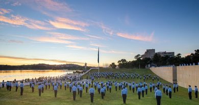 Australian Defence Force Academy Air Force trainee officers stand at attention during the raising of the RAAF Ensign at Commonwealth Place on 31 March 2021. Photo by Lannon Harley.