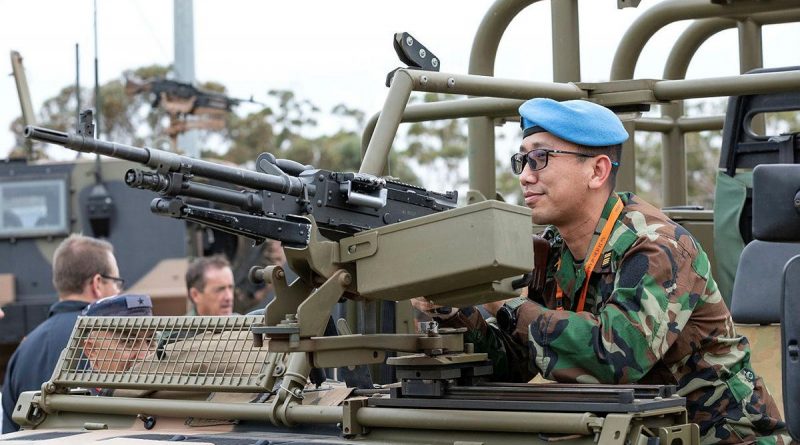 Defense Attaché to the Royal Embassy of Cambodia, Colonel Khanrithy Morn from the Royal Cambodian Army, inspects the weapon system mounted to a No. 3 Security Forces Squadron vehicle at RAAF Base Edinburgh. Story by Lieutenant Gordon Carr-Gregg. Photo by Leading Aircraftman Sam Price.