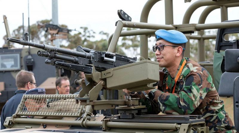 Defense Attaché to the Royal Embassy of Cambodia, Colonel Khanrithy Morn from the Royal Cambodian Army, inspects the weapon system mounted to a No. 3 Security Forces Squadron vehicle at RAAF Base Edinburgh. Story by Lieutenant Gordon Carr-Gregg. Photo by Leading Aircraftman Sam Price.