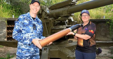 Commanding Officer No. 35 Squadron Wing Commander Scott Egan presents the curator of the Torres Strait Heritage Museum, Vanessa Seekee, with a replica 3.7-inch shell. Story by Flying Officer Robert Hodgson. Photo by Corporal Brett Sherriff.
