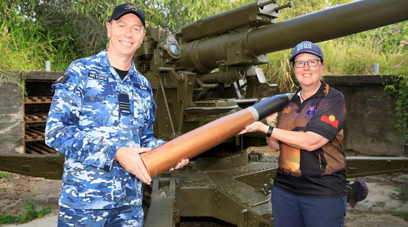 Commanding Officer No. 35 Squadron Wing Commander Scott Egan presents the curator of the Torres Strait Heritage Museum, Vanessa Seekee, with a replica 3.7-inch shell. Story by Flying Officer Robert Hodgson. Photo by Corporal Brett Sherriff.